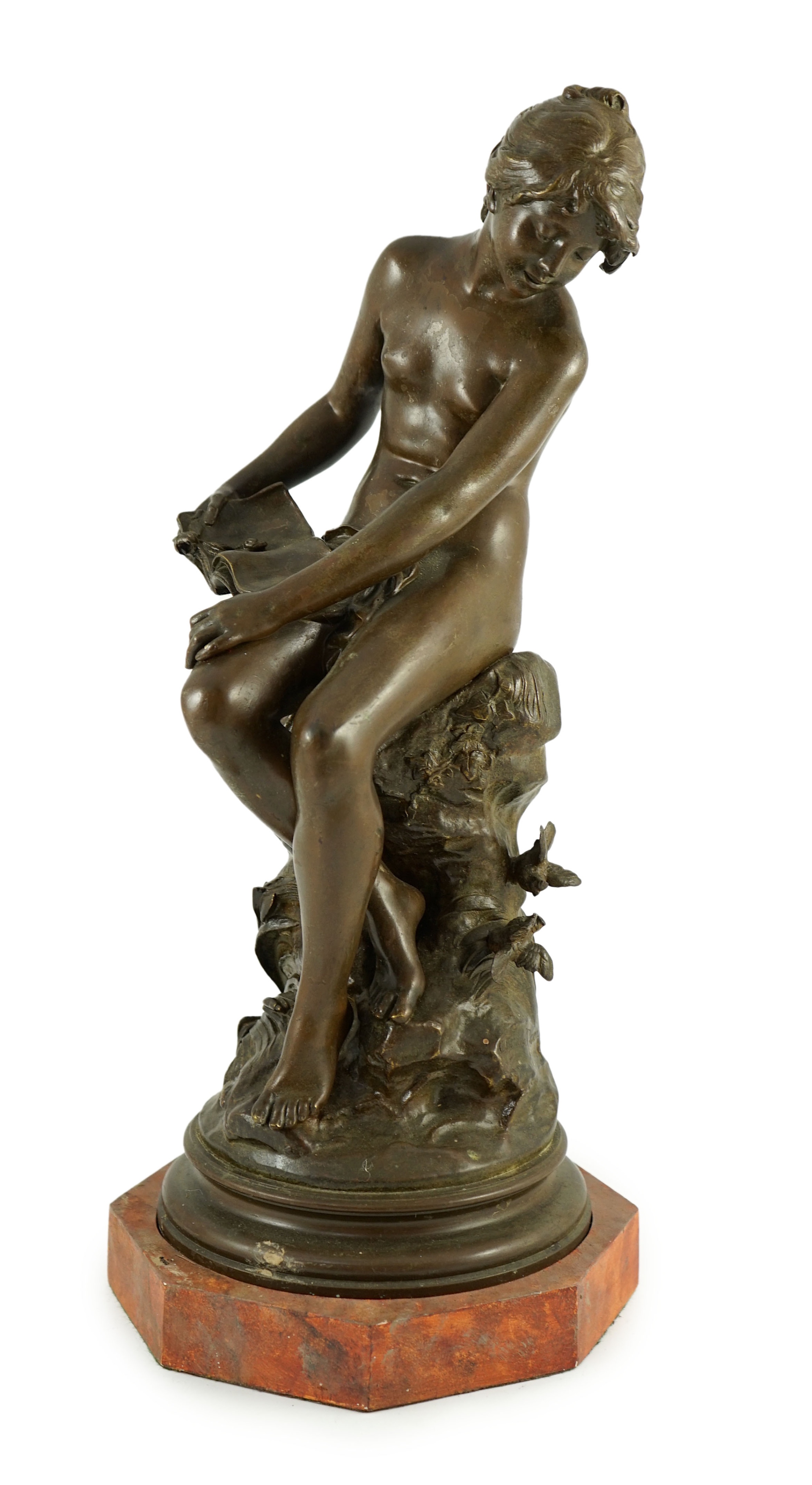 Auguste Moreau (French, 1834-1917). A bronze figure of a nude girl seated on a mound holding a book with birds at her feet, overall height 45cm